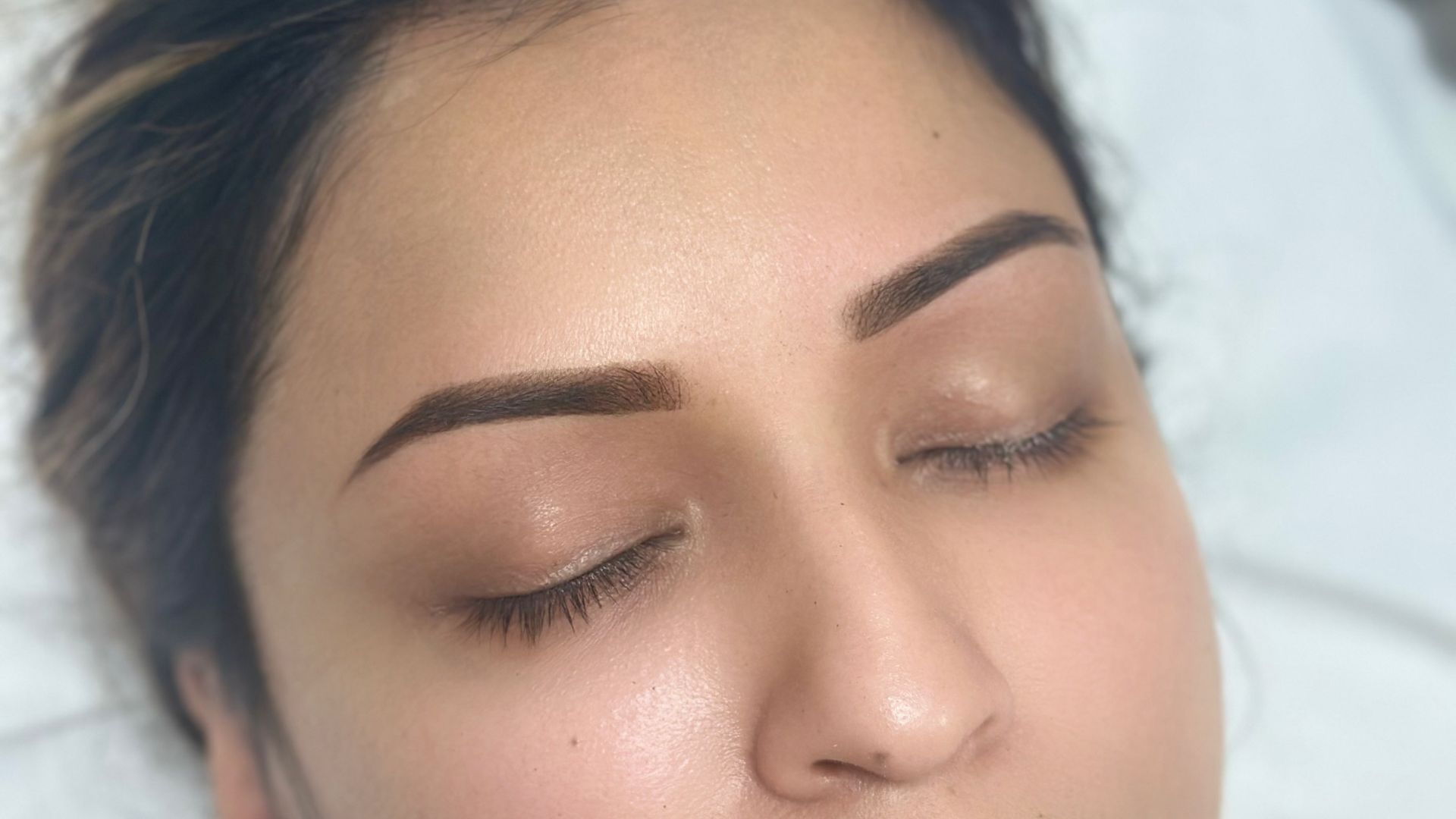 Sparse brows showing areas of reduced natural brow hair before permanent makeup treatment.